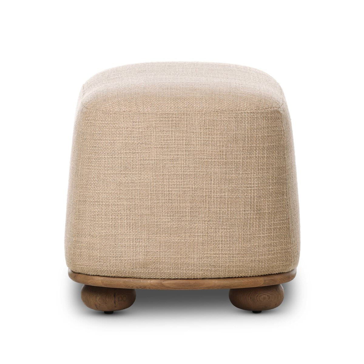 Side of Four Hands Bilbury Oval Ottoman in Saxon Sand on a white background at Addison West