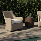 Four Hands Blaire Outdoor Swivel Chair in Vintage White on a patio at Addison West