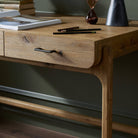 Close up of Four Hands Bloomfield Desk in Resawn Worn Oak in an office at Addison West