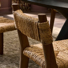 Close up of Four Hands Bovard Dining Chair in Stained Toasted Brown in a dining room at Addison West