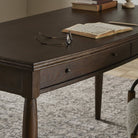 Close up of Four Hands Bowfront Desk in Drifted Oak Veneer in an office at Addison West