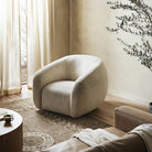 Four Hands Channing Swivel Chair in Yuma Cream in a living room at Addison West