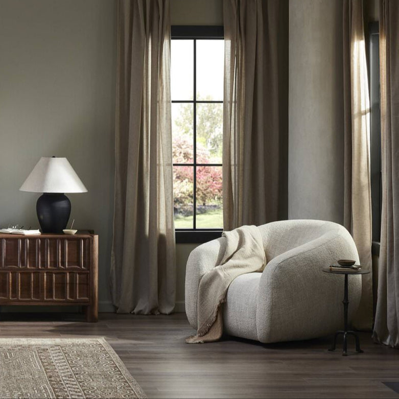 Four Hands Channing Swivel Chair in Yuma Cream in a bedroom at Addison West