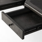 Close up of Four Hands Claude Desk in Distressed Black Oak Veneer on a white background at Addison West