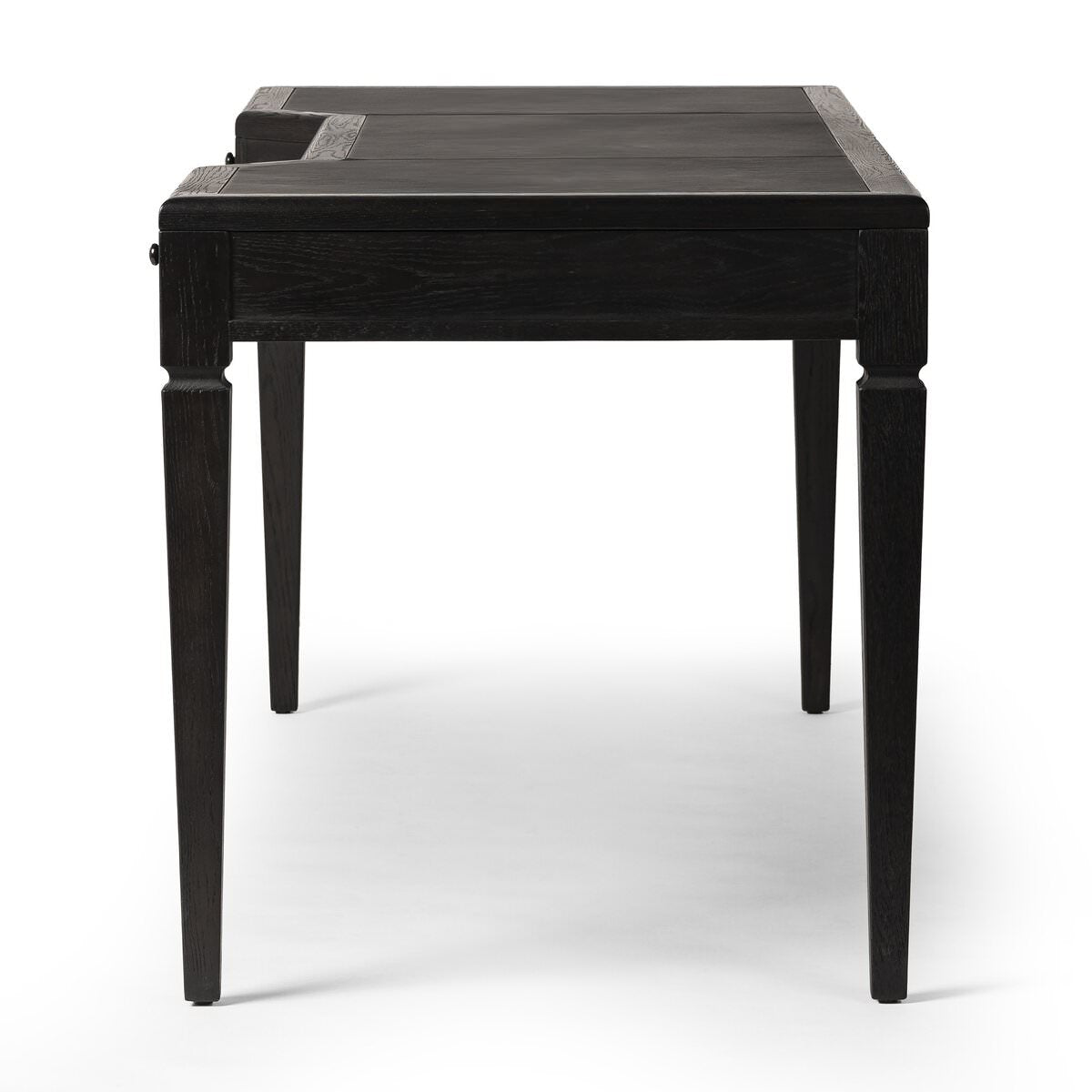 Side of Four Hands Claude Desk in Distressed Black Oak Veneer on a white background at Addison West