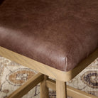 Close up of Four Hands Cloris Swivel Counter Stool in Palermo Cigar in dining room at Addison West.