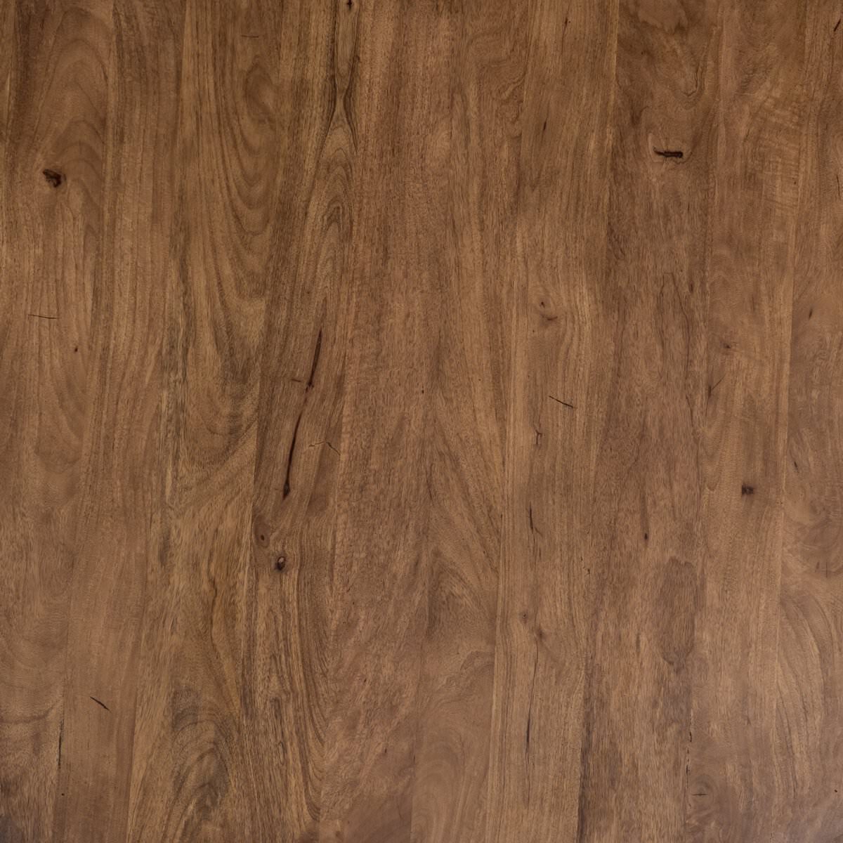 Close up of Four Hands Cobain Round 60" Dining Table in Reclaimed Mango on a white background