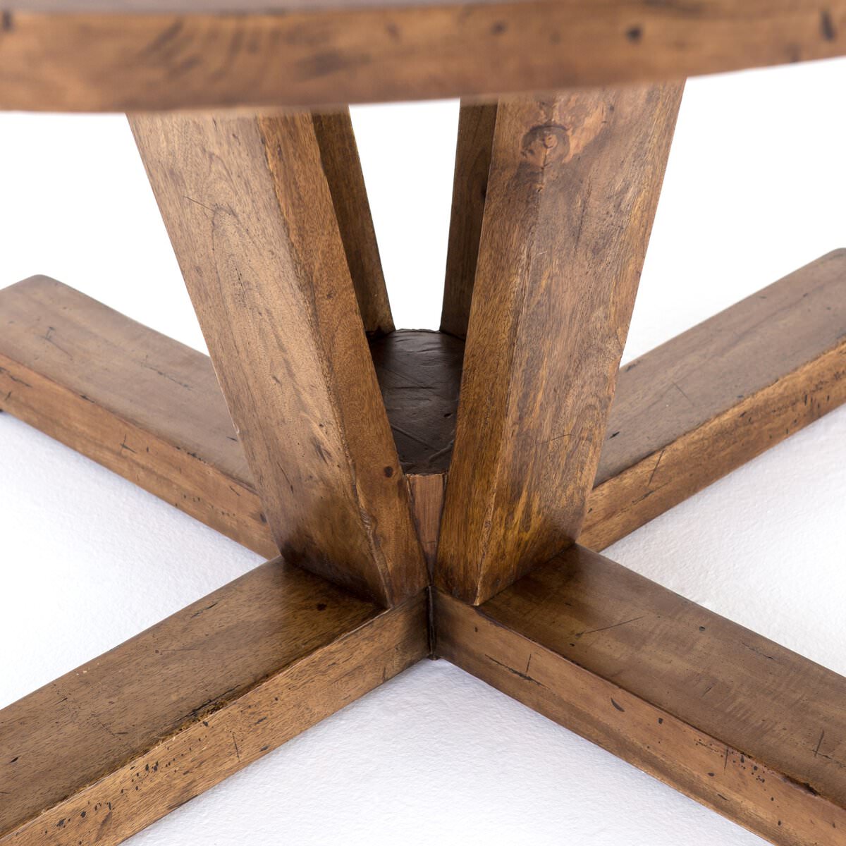 Close up of Four Hands Cobain Round 60" Dining Table in Reclaimed Mango on a white background