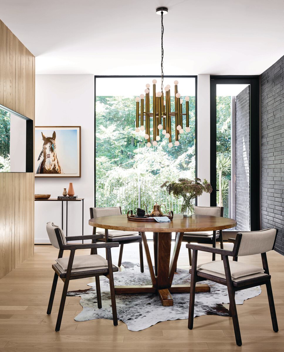 Four Hands Cobain Round 60" Dining Table in Reclaimed Mango in a modern dining room