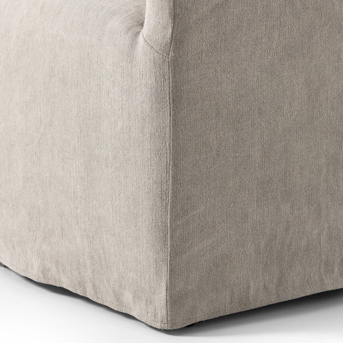 Close up of Four Hands Cove Dining Chair With Casters in Heather Twill Stone on a white background