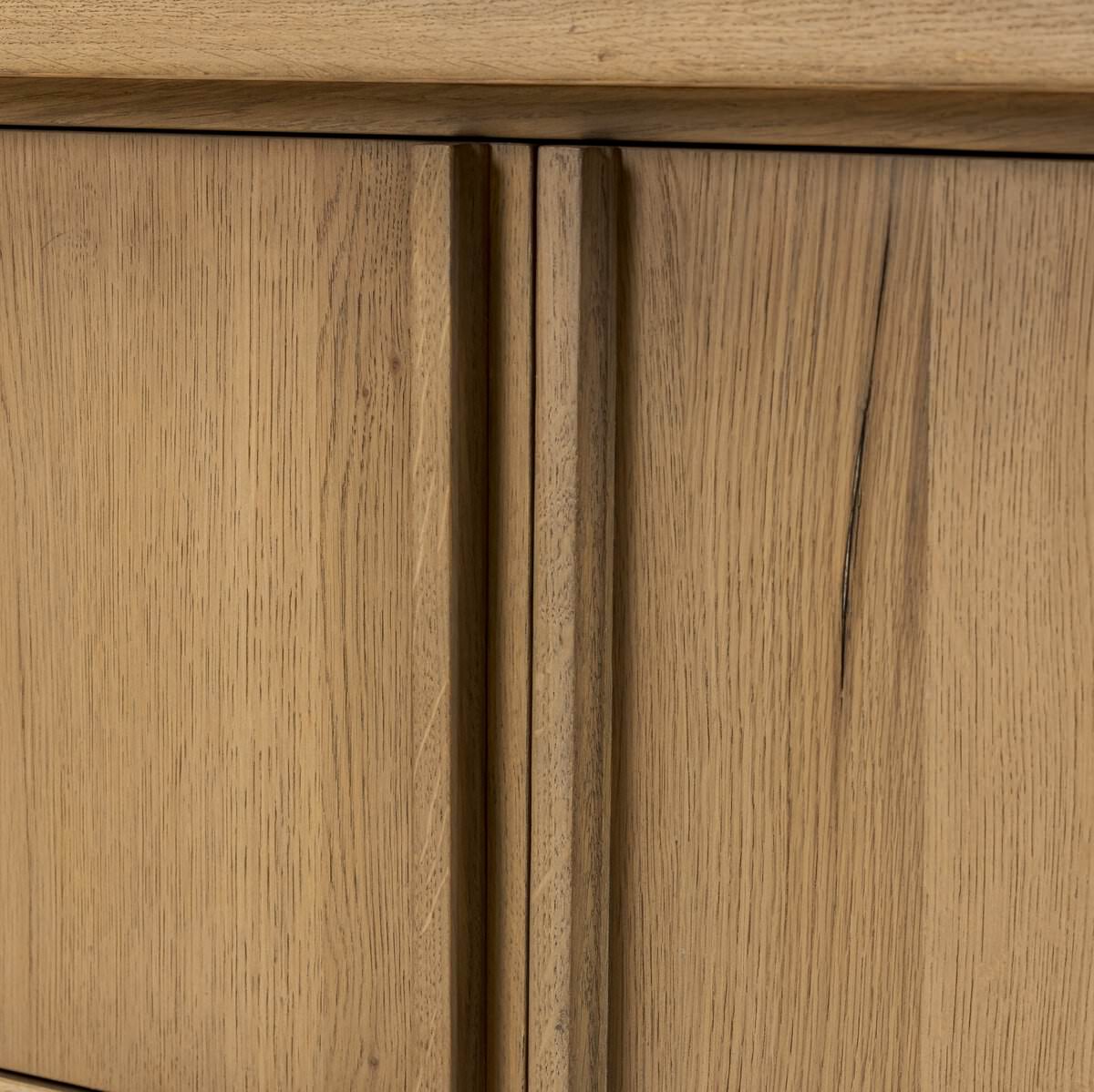 Close up of Four Hands Dalton Media Console in Aged Natural Oak Veneer on a white background at Addison West