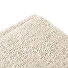 Close up of Four Hands Daniel Ottoman in Ivan Sand on a white background at Addison West