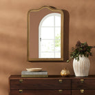Four Hands Effie Mirror in Raw Antique Brass in a living room at Addison West