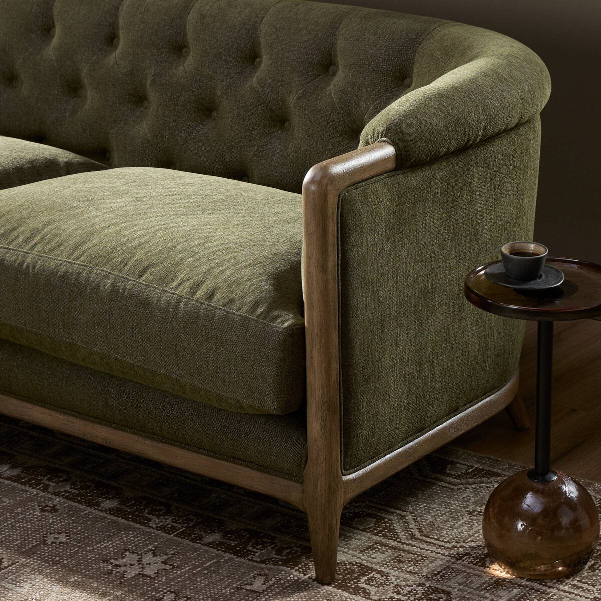 Close up of Four Hands Ellsworth Sofa in Sutton Olive in a living room at Addison West