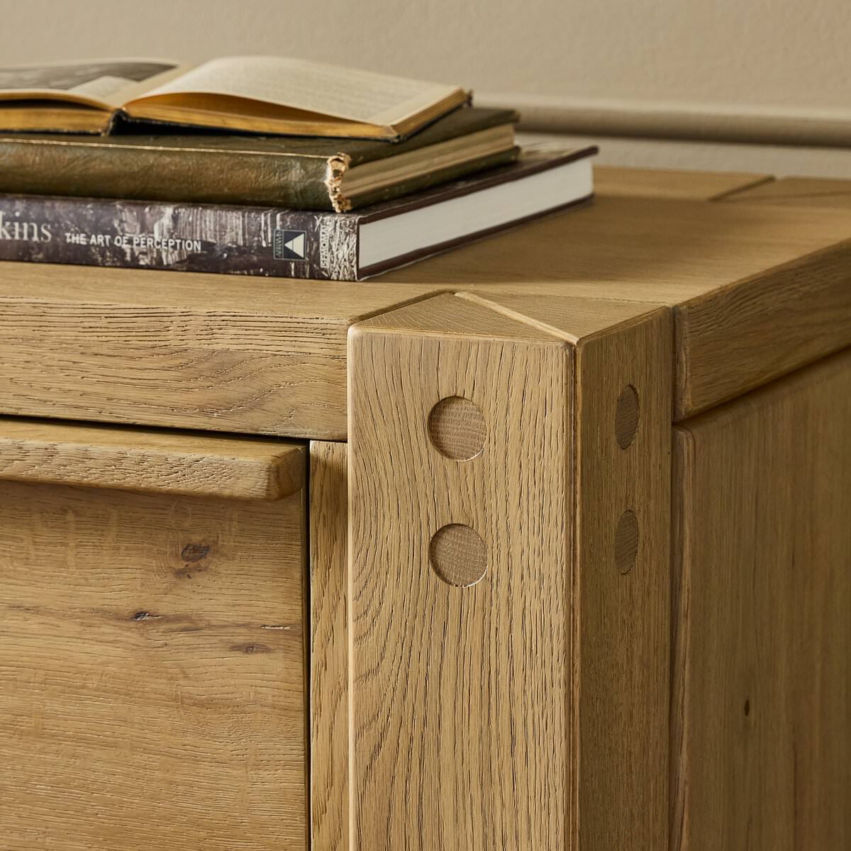 Close up of Four Hands Emmer 6 Drawer Dresser in Aged Smoked Oak Veneer in a bedroom at Addison West