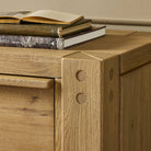 Close up of Four Hands Emmer 6 Drawer Dresser in Aged Smoked Oak Veneer in a bedroom at Addison West