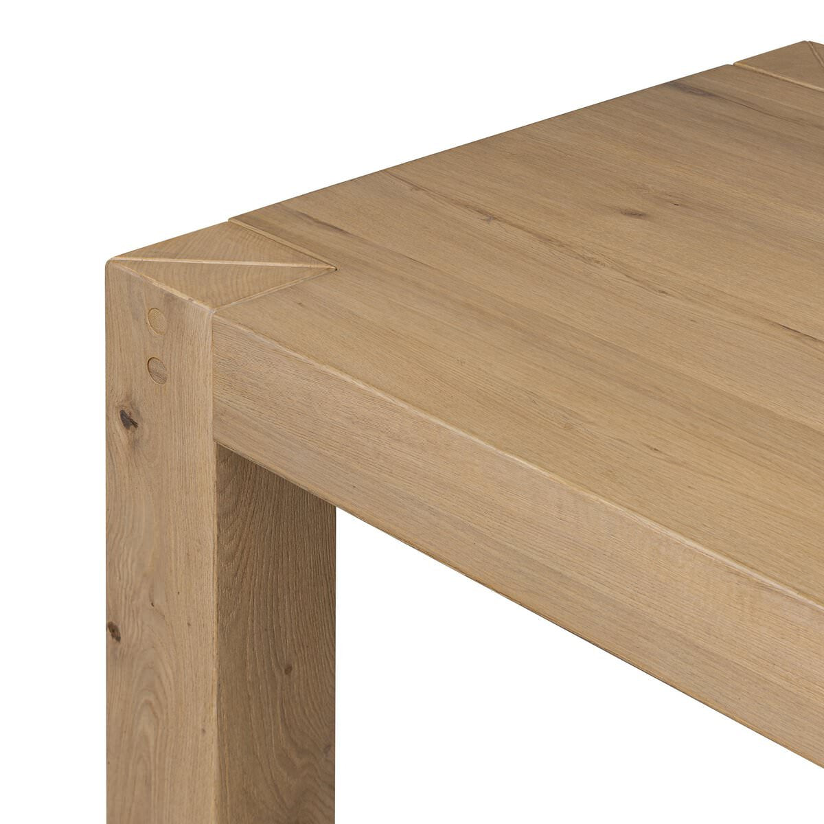 Close up of Four Hands Emmer Dining Table in Aged Smoked Oak on a white background at Addison West
