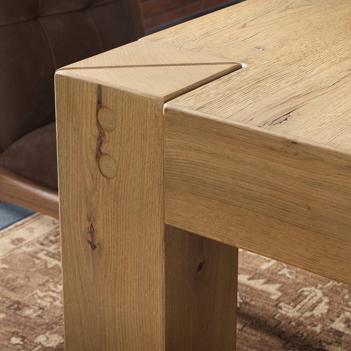 Close up of Four Hands Emmer Dining Table in Aged Smoked Oak in a dining room at Addison West