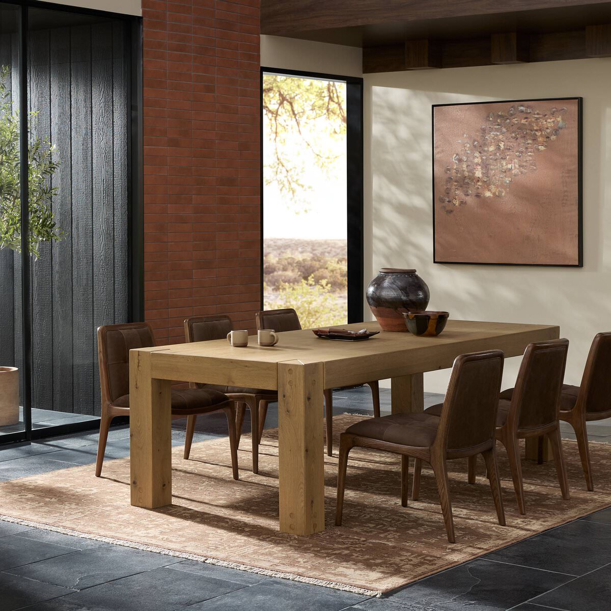 Four Hands Emmer Dining Table in Aged Smoked Oak in a dining room at Addison West