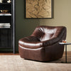 Four Hands Farley Swivel Chair In Conroe Cigar in a cozy living space with dark walls and beige rug