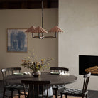 Four Hands Fiorella Chandelier in Black Wrought Iron in a dining room at Addison West