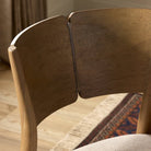 Close up of Four Hands Grady Counter Stool in Alcala Taupe in a dining room at Addison West