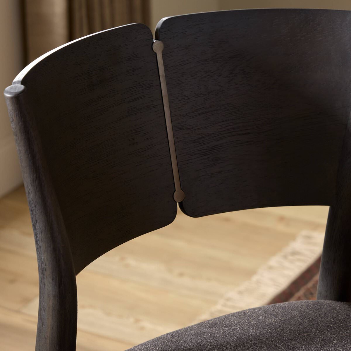 Close up of Four Hands Grady Counter Stool in Antwerp Noir in a dining room at Addison West