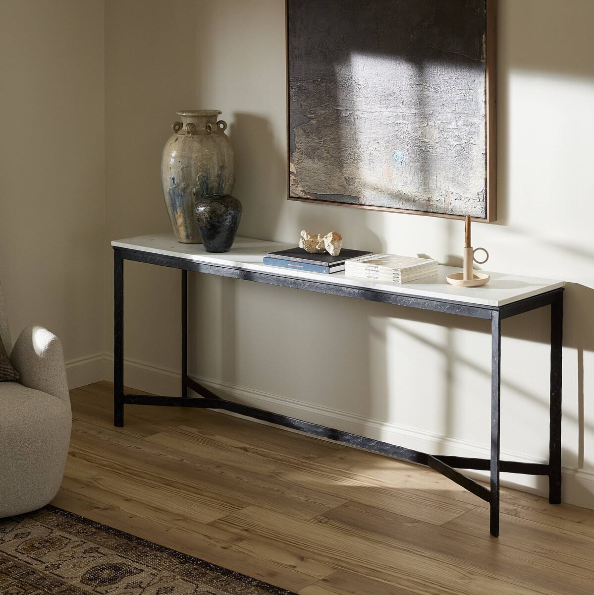 Four Hands Hammered Iron Console Table against a white wall in a living room at Addison West