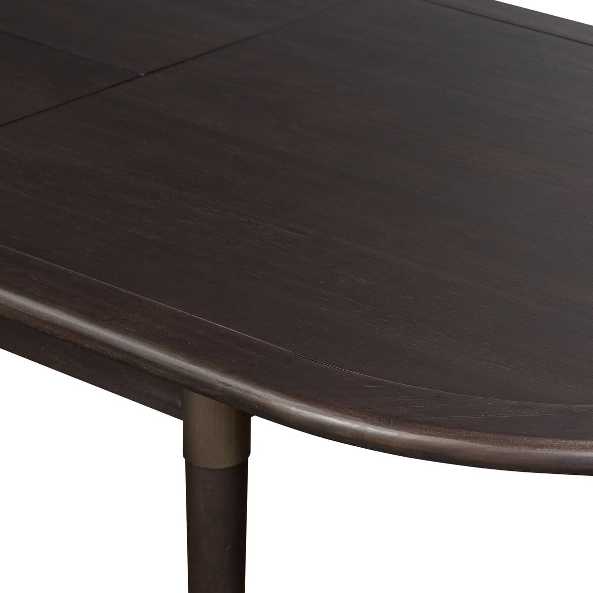 Close up of Four Hands Harper Oval Extension Dining Table 84-104" in Black Mango Veneer on a white background at Addison West