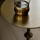 Four Hands Jocelyn End Table in Dark Brass in living room at Addison West.