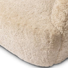Close up of Four Hands Julius Swivel Chair in Beige Shearling on a white background at Addison West