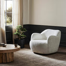 Four Hands Julius Swivel Chair in Sheldon Ivory in a living room at Addison West