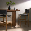 Four Hands Kena Bar Stool In Sonoma Black in a dining space with bar height table