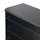 Close up of corner of Four Hands Lendon 6 Drawer Dresser in Black on a white background