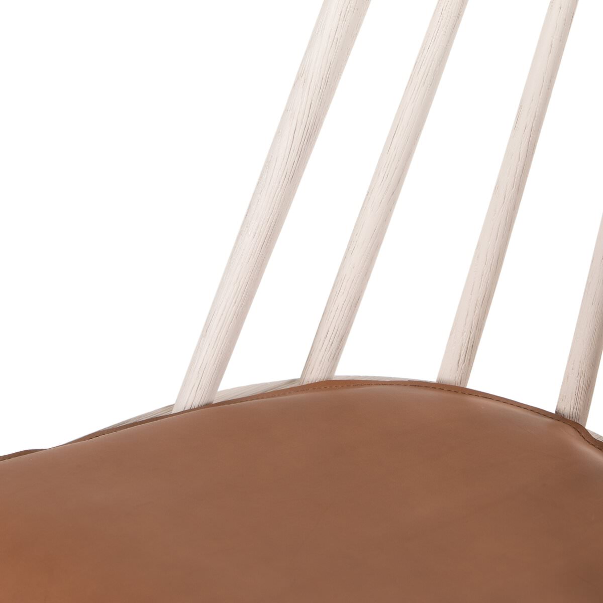Close up of Four Hands Lewis Windsor Chair in Off White Whiskey Saddle on a white background