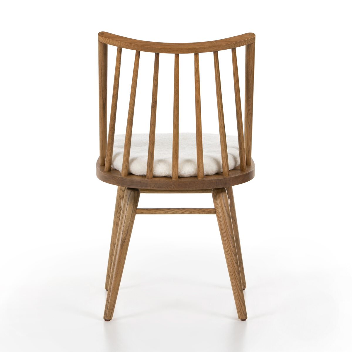 Four Hands Lewis Windsor Chair in Sandy Oak Shorn Sheepskin on a white background