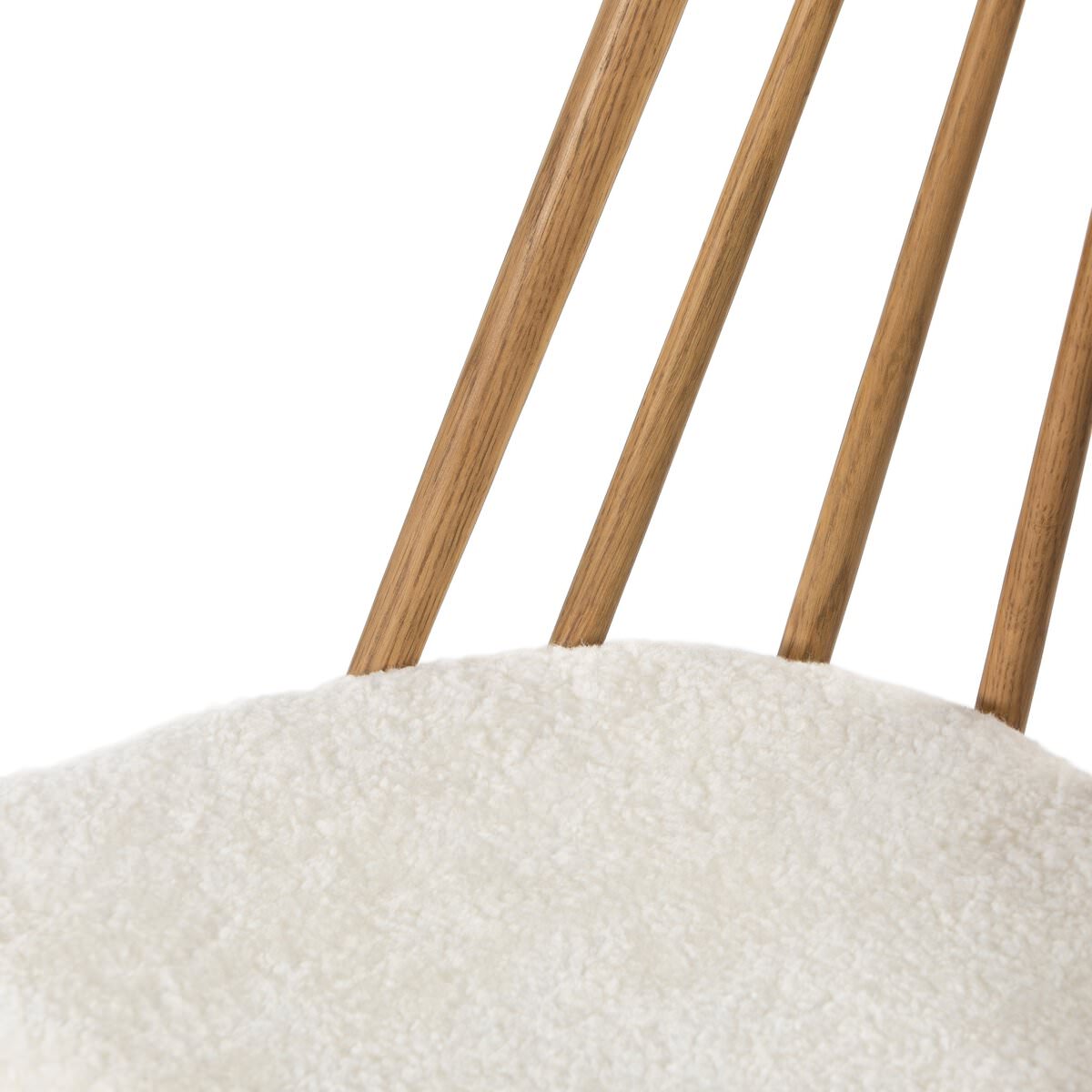 Close up of Four Hands Lewis Windsor Chair in Sandy Oak Shorn Sheepskin on a white background