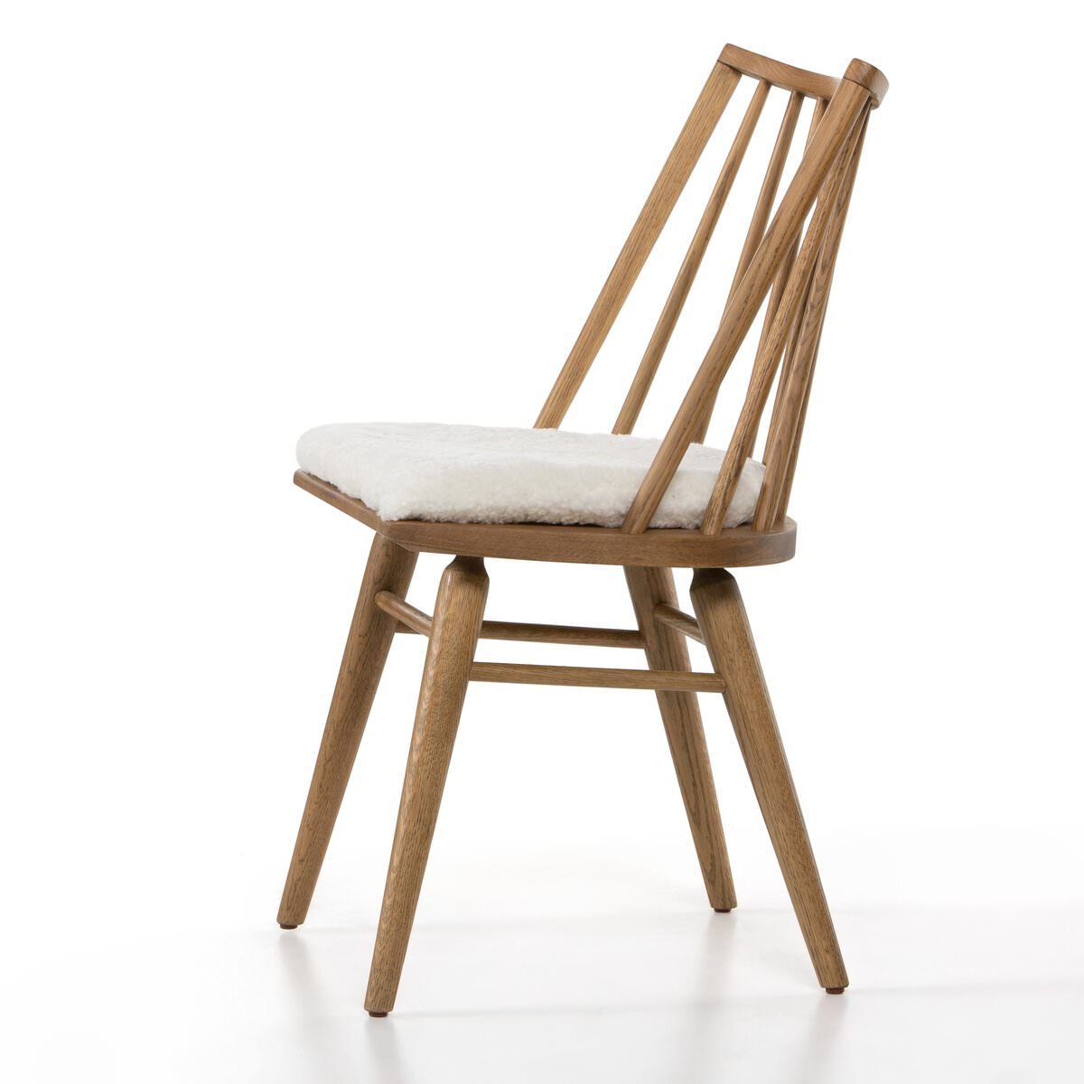 Four Hands Lewis Windsor Chair in Sandy Oak Shorn Sheepskin on a white background