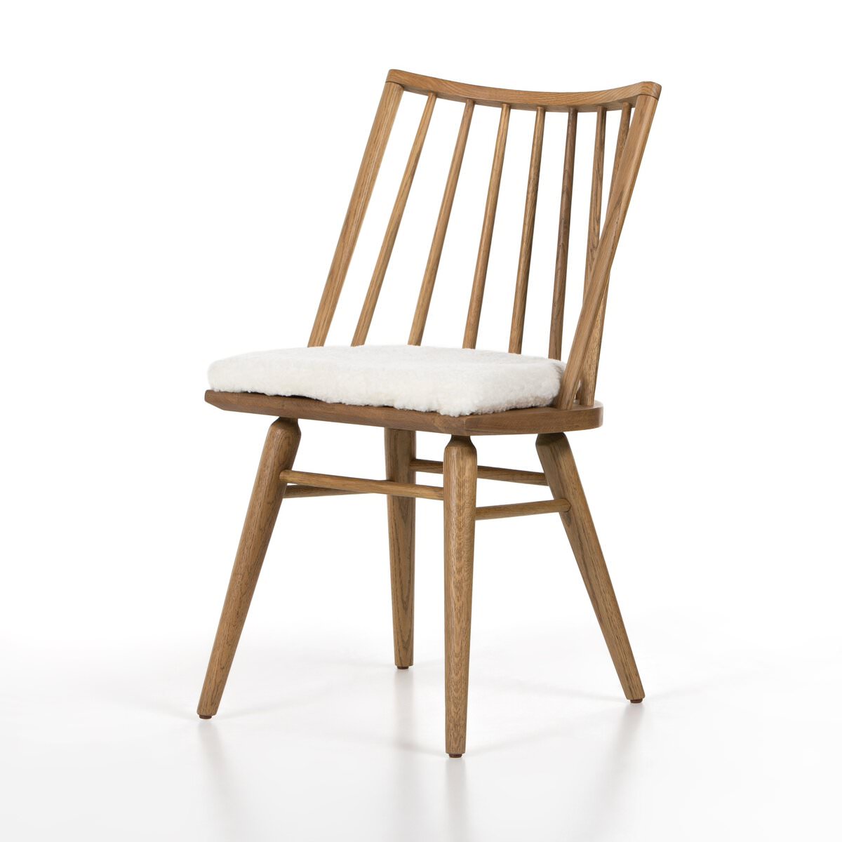 Four Hands Lewis Windsor Chair in Sandy Oak Shorn Sheepskin on a white background