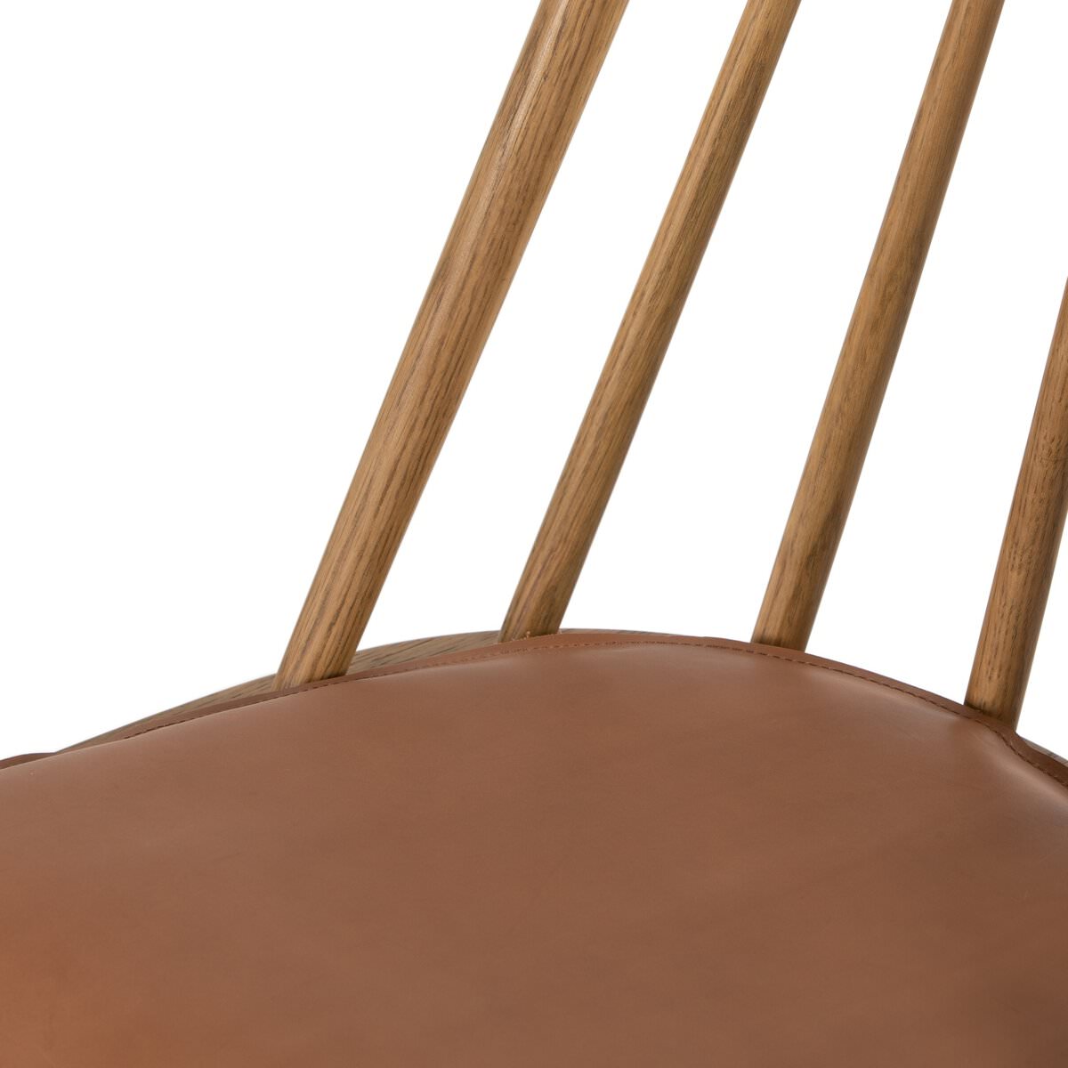 Close up of Four Hands Lewis Windsor Chair in Sandy Oak Whiskey Saddle on a white background