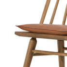Four Hands Lewis Windsor Chair in Sandy Oak Whiskey Saddle on a white background