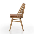 Four Hands Lewis Windsor Chair in Sandy Oak Whiskey Saddle on a white background