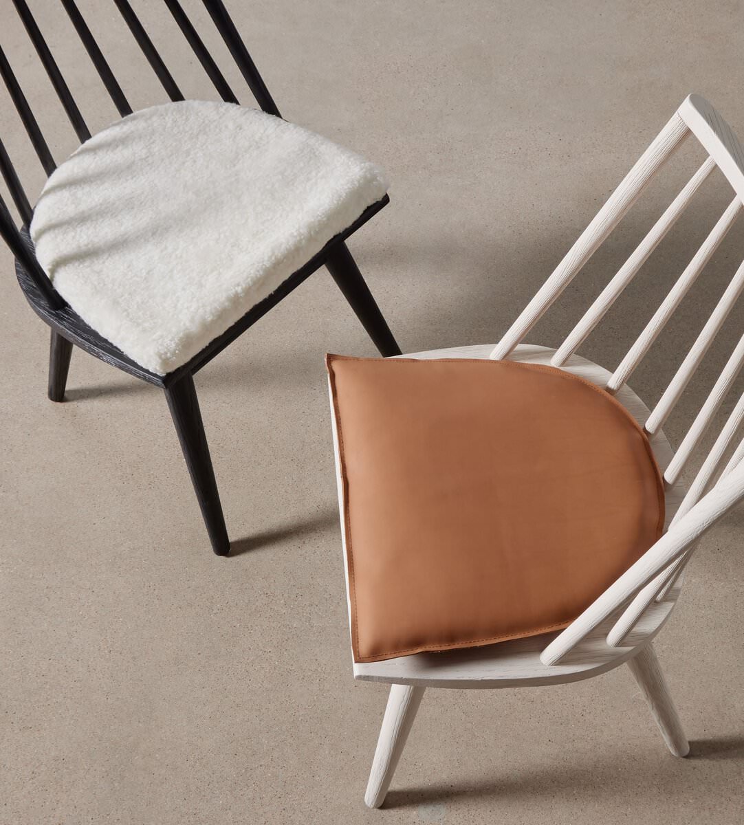 Four Hands Lewis Windsor Chair in Sandy Oak Whiskey Saddle on a beige background