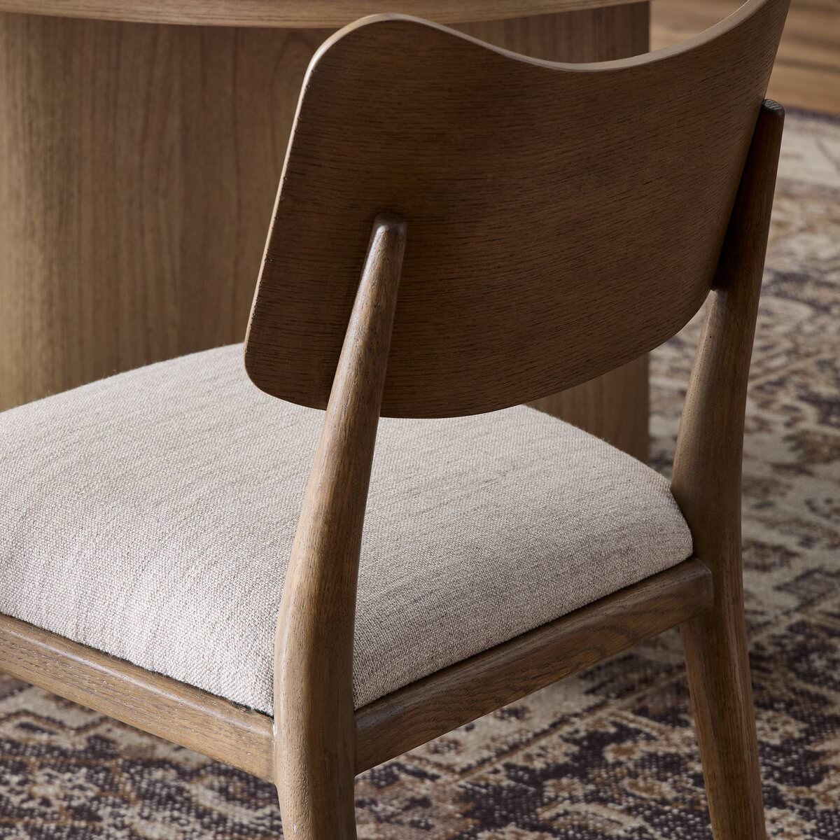 Close up of Four Hands Marley Dining Chair in Alcala Wheat in a dining room at Addison West
