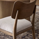 Close up of Four Hands Marley Dining Chair in Alcala Wheat in a dining room at Addison West