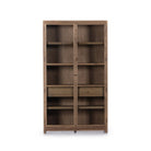 Four hands furniture brand Millie oak cabinet with glass doors and four shelves and interior drawer on a white background