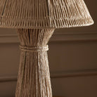 Close up of Four Hands Nessa Table Lamp in Antique Brass Iron on a table at Addison West