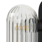 Close up of Four Hands Odyssey Sconce in Black Gunmetal on a white background at Addison West