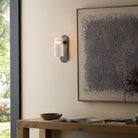 Four Hands Odyssey Sconce in Black Gunmetal on a wall at Addison West