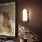 Four Hands Odyssey Sconce in Heritage Bronze Brass with Opal Matte Glass, 15" in living room at Addison West.